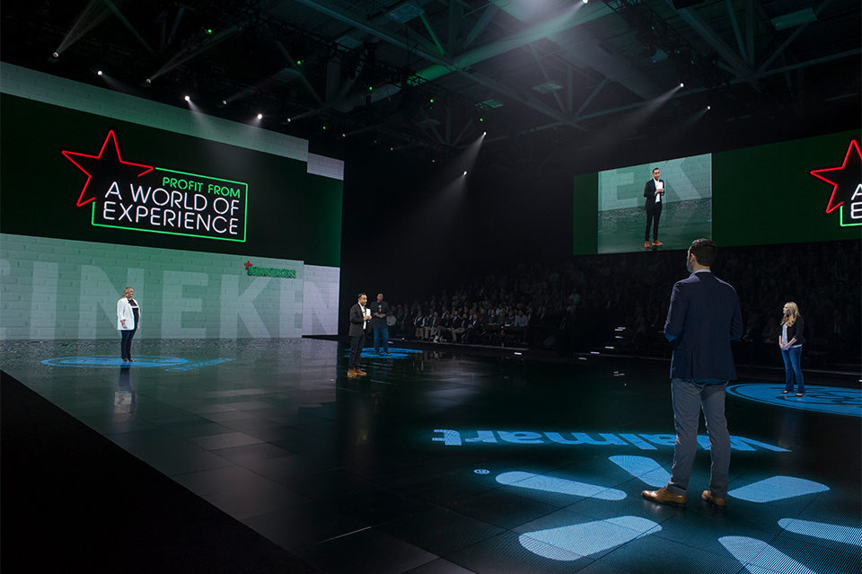 Photo of 5 people on LED stage with Heineken branding