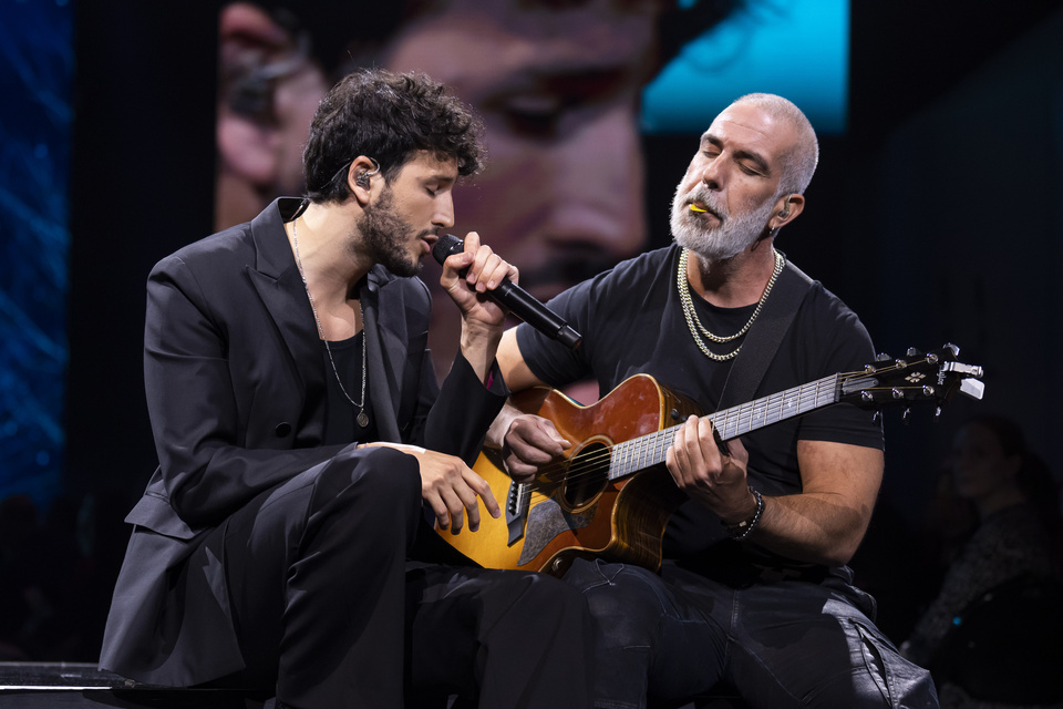 Photo of a Singer and Guitarist on stage performing together.