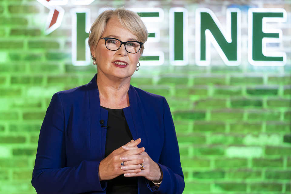 Photo of Heineken USA CEO speaking in front of green brick wall with Heineken logo