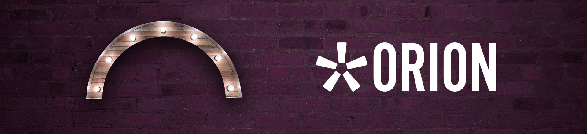 Marquee-style arch Proscenium logo and Orion logo on a plum-colored brick wall background.