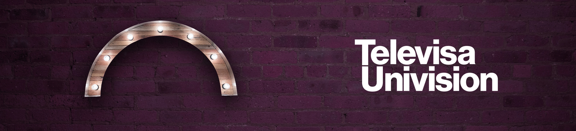 Marquee-style arch Proscenium logo and Televisa Univision logo on a plum-colored brick wall background.