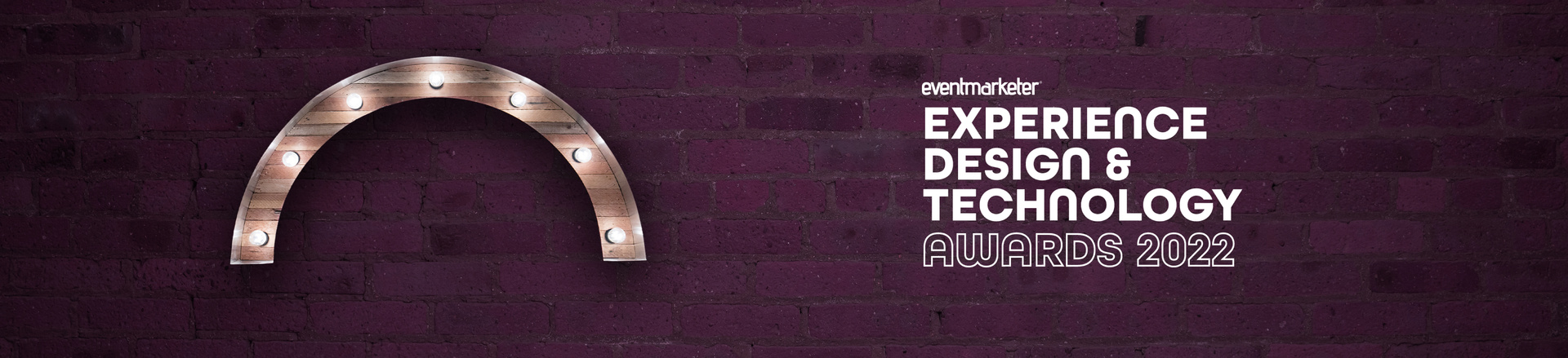 Marquee-style arch Proscenium logo and Event Marketer Experience Design & Technology Awards 2022 logo on a plum-colored brick wall background.
