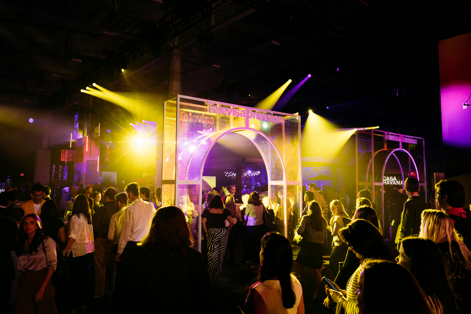 Photo of guests mingling at a Televisa Univision event with event floor arch branding